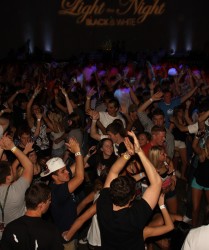 Students dancing in a school event with a DJ.